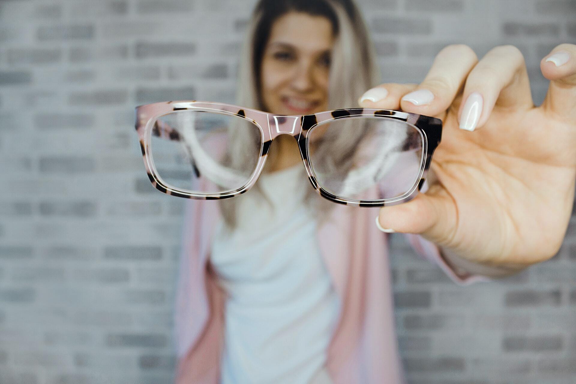 Selective focus of photography of pink and black framed eyeglasses